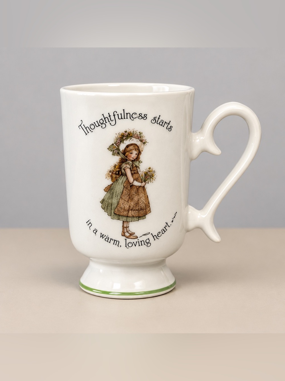 1974 Holly Hobbie porcelain pedestal mug says, thoughtfulness starts in a warm
